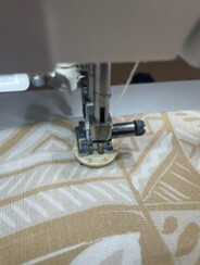 Sewing machine stitching a patterned fabric in a New South Wales workshop.