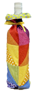 Colorful patchwork fabric wine bottle cover by a West Gosford sewing brand.